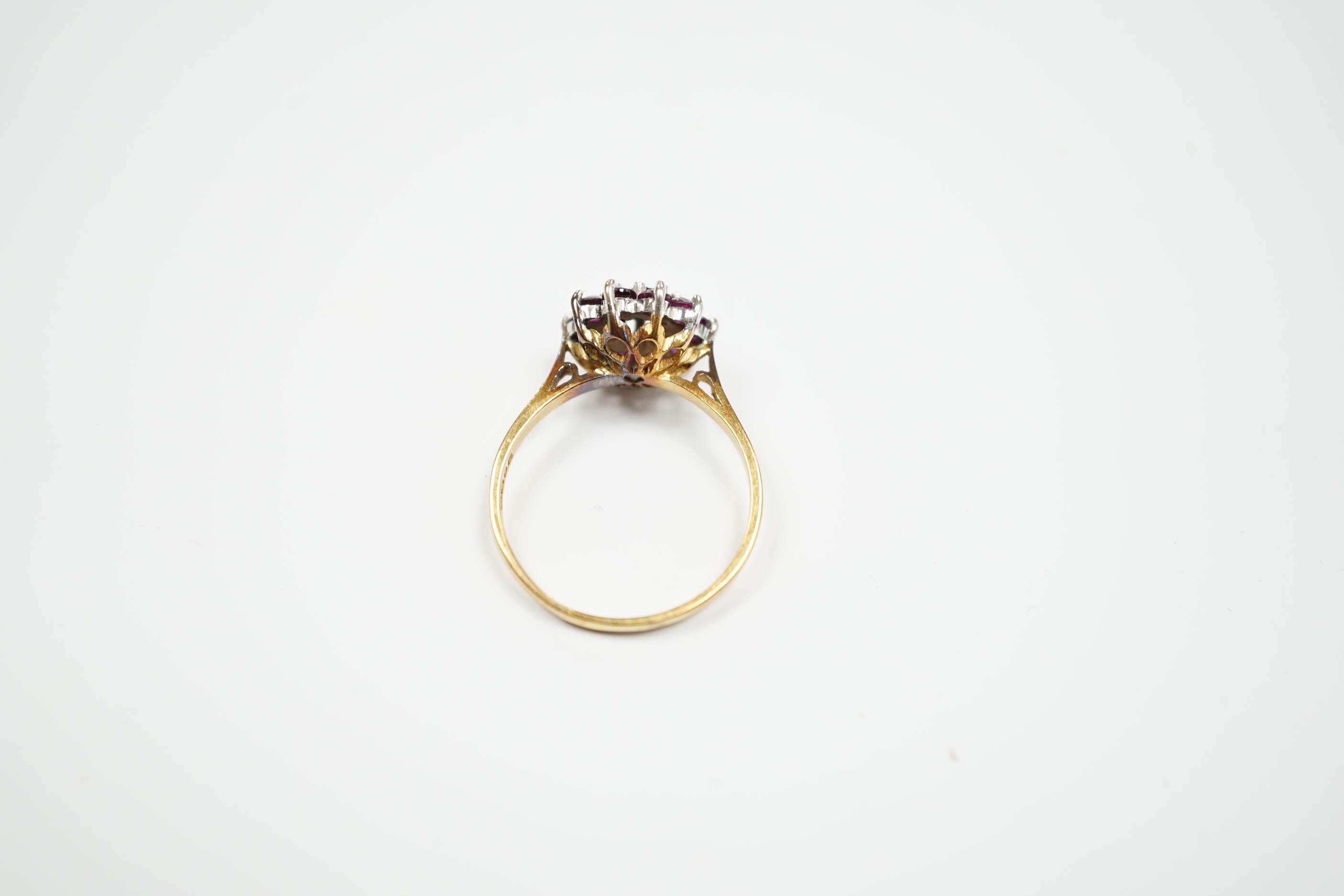 A modern 18ct gold, ruby and diamond cluster set flower head ring, size R, gross weight 4.2 grams.